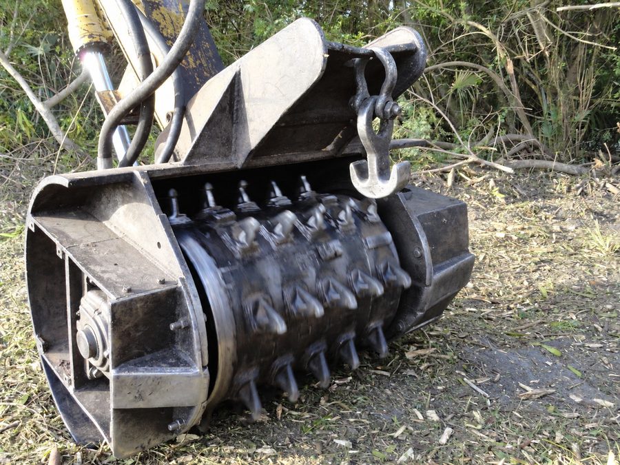 Forestry mulching attachment above shredded brush